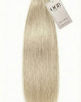 A bundle of long, straight, platinum blonde OGB hair extensions with a white tag attached