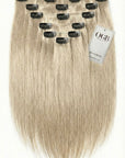 Set of blonde hair extensions with clips on a white background, featuring the OGB label.